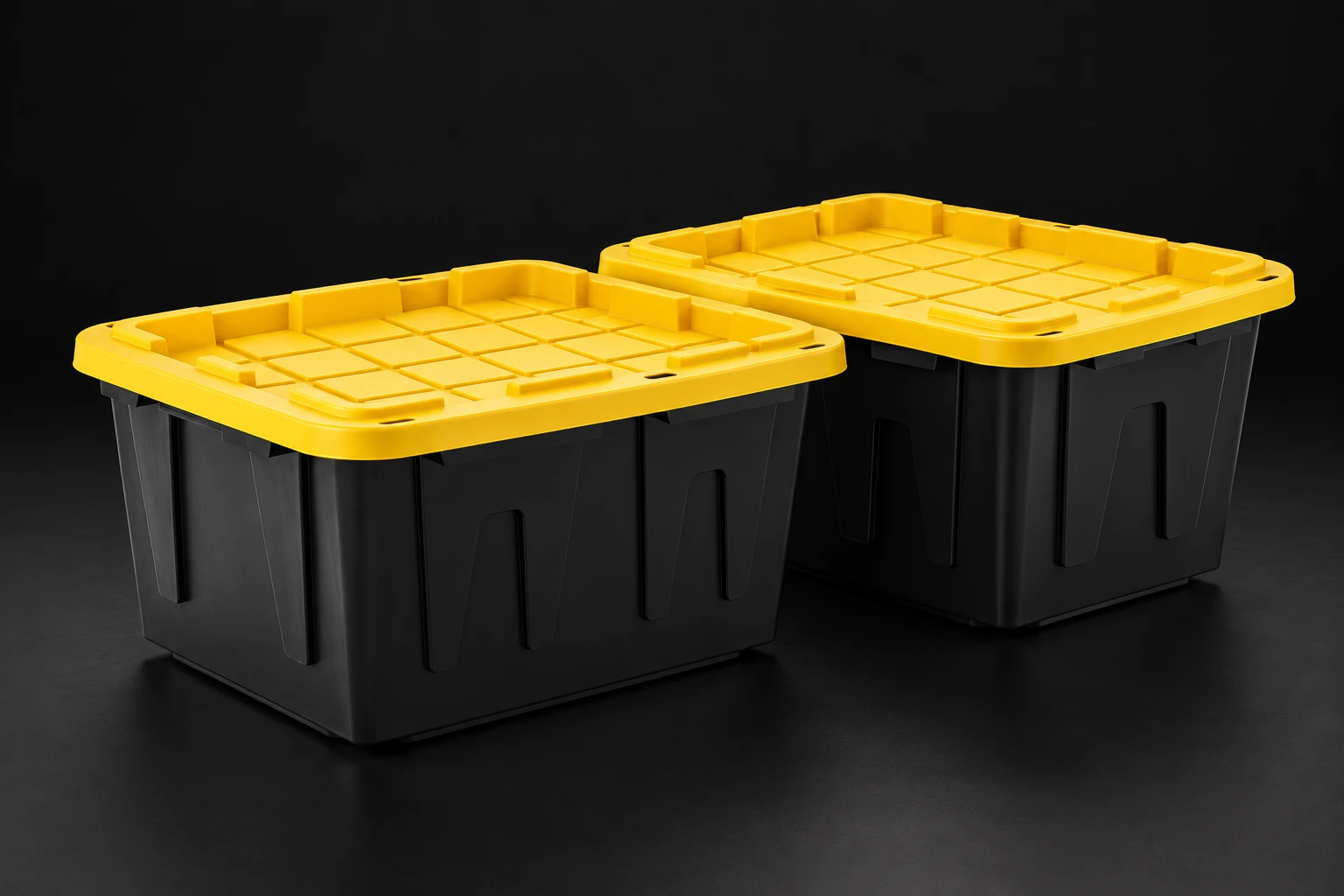 Two black totes with yellow lids on a dark background.